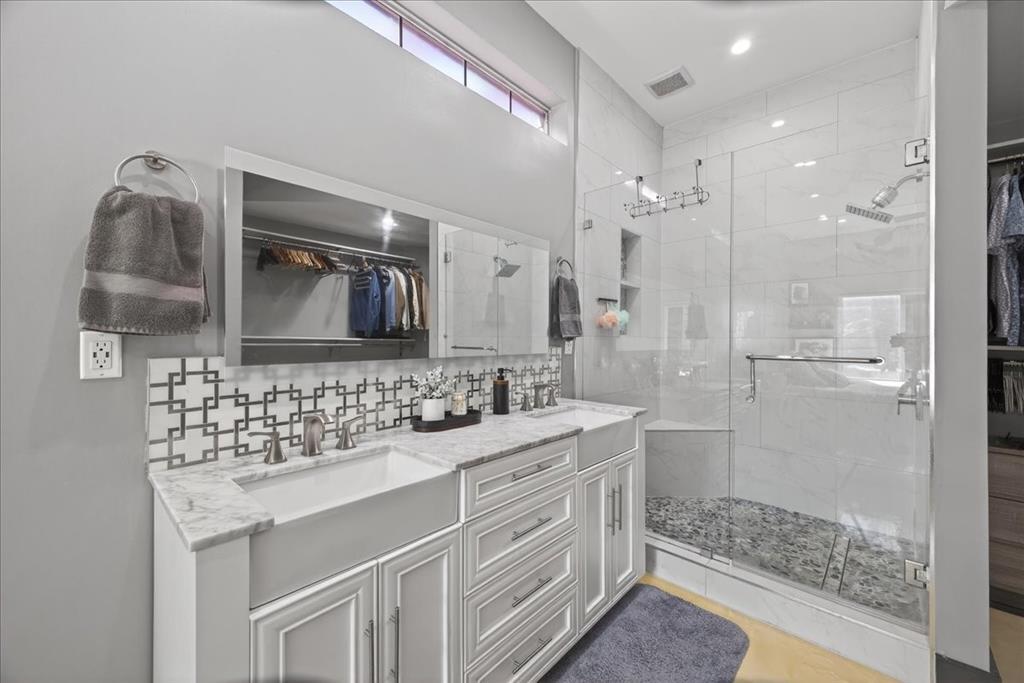 2934 North Bend Drive Dallas, TX 75229 - Photo 23 of 30 a bathroom with a sink a toilet a shower and mirror