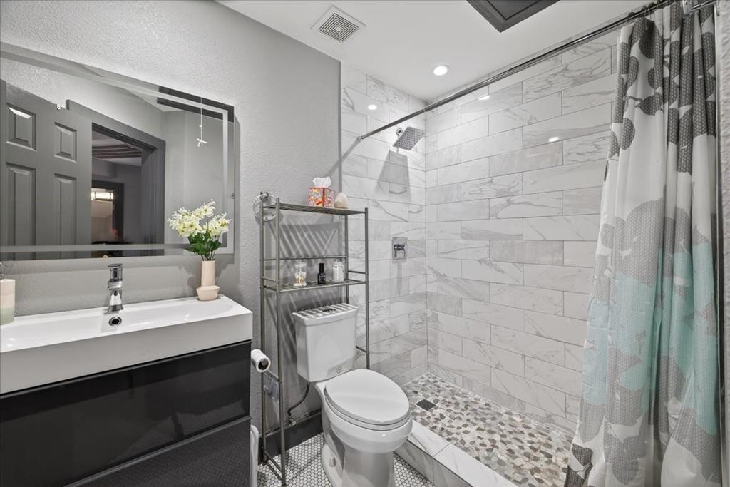 2934 North Bend Drive Dallas, TX 75229 - Photo 25 of 30 a bathroom with a sink toilet and shower