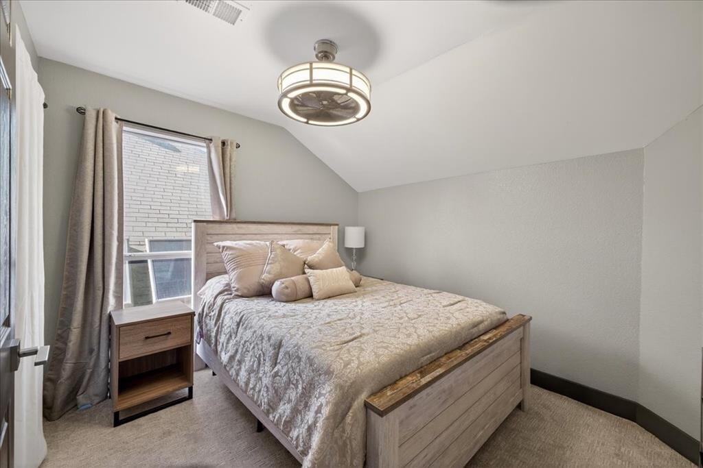 2934 North Bend Drive Dallas, TX 75229 - Photo 26 of 30 a bedroom with a large bed and a chandelier