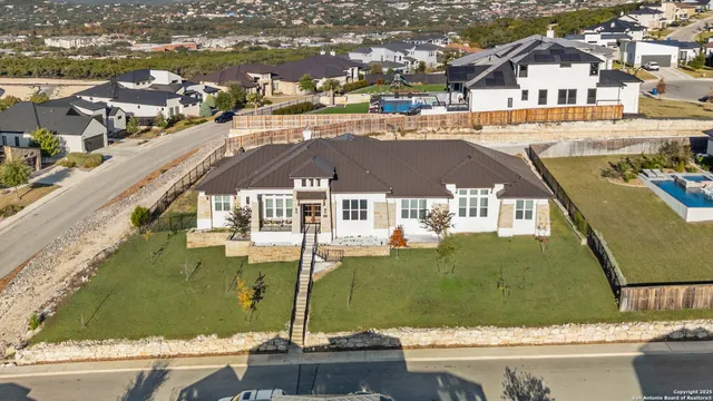 an aerial view of residential houses with outdoor space