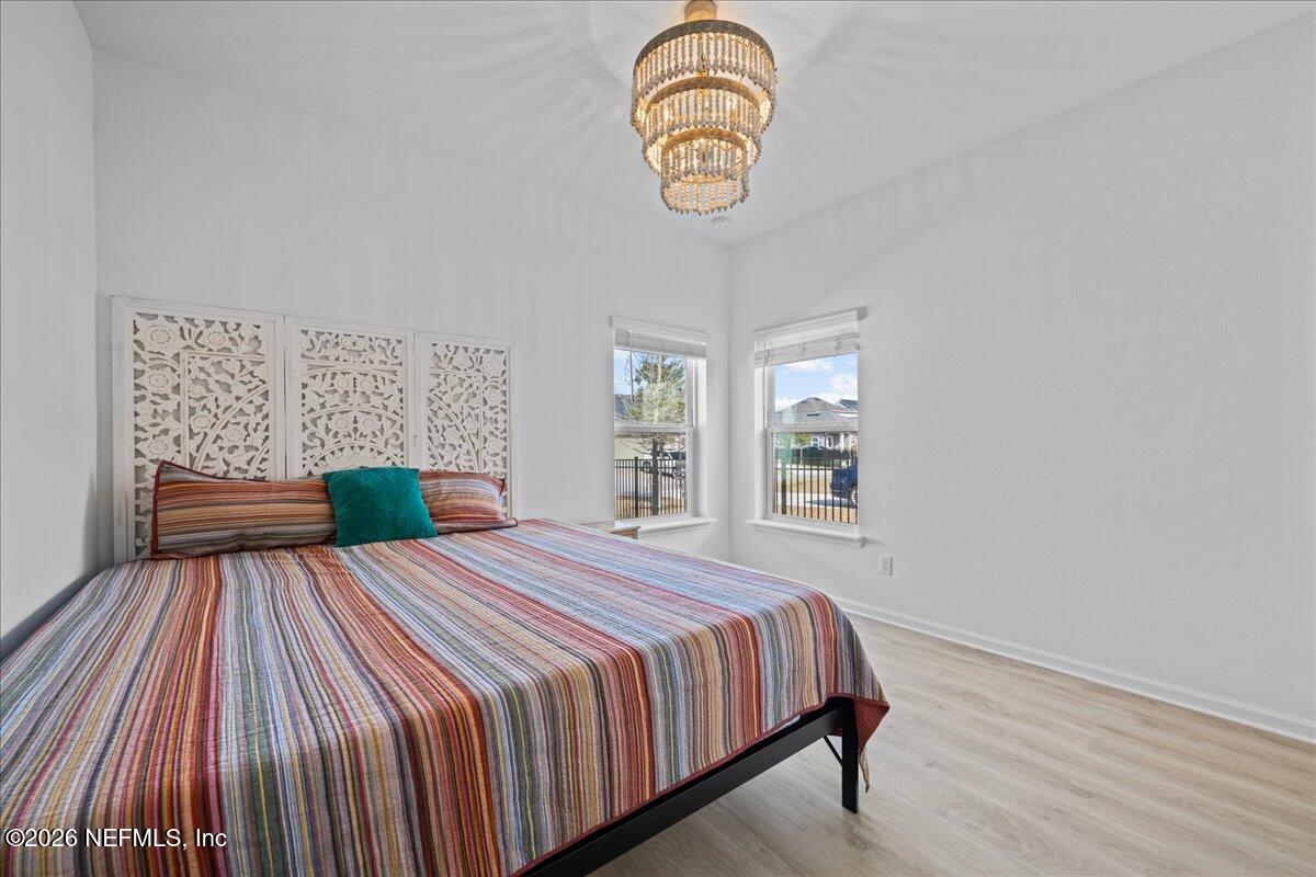 92 Patina Place St. Augustine, FL 32092 - Photo 13 of 26 a bedroom with a bed and wooden floor