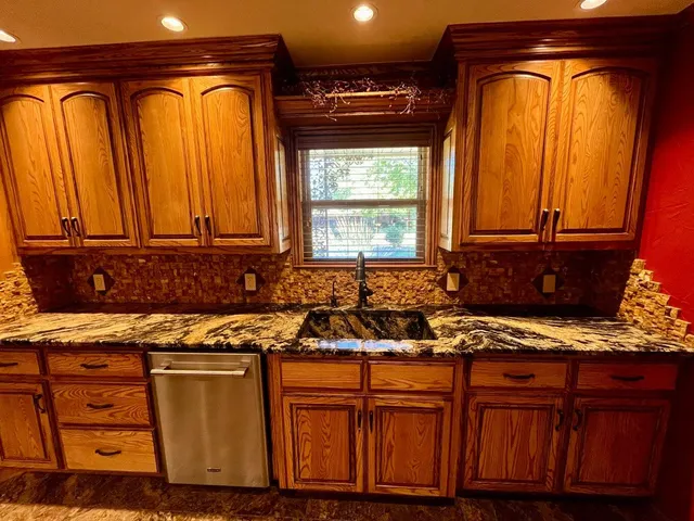 a stove top oven sitting inside of a kitchen