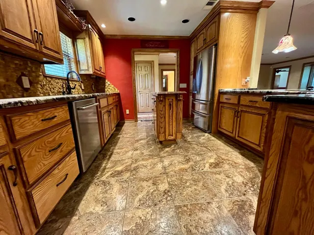 a stove top oven sitting inside of a kitchen
