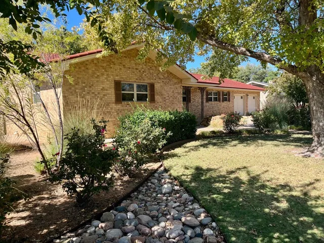 a backyard of a house with yard barbeque oven and outdoor seating