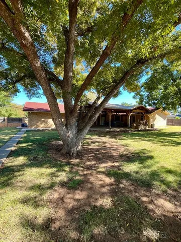 a view of a patio with table and chairs
