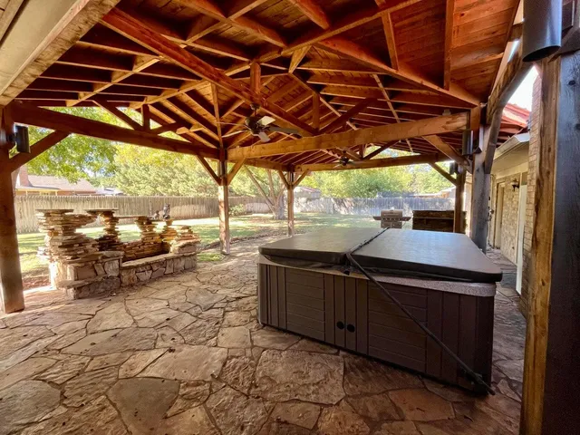 a view of a house with backyard porch and sitting area