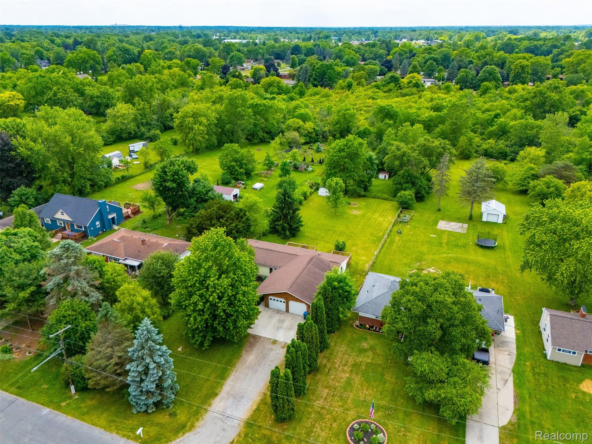 4420 Dublin Road Burton, MI 48529 - Photo 46 of 56 Aerial property view featuring extensive green spaces and mature trees