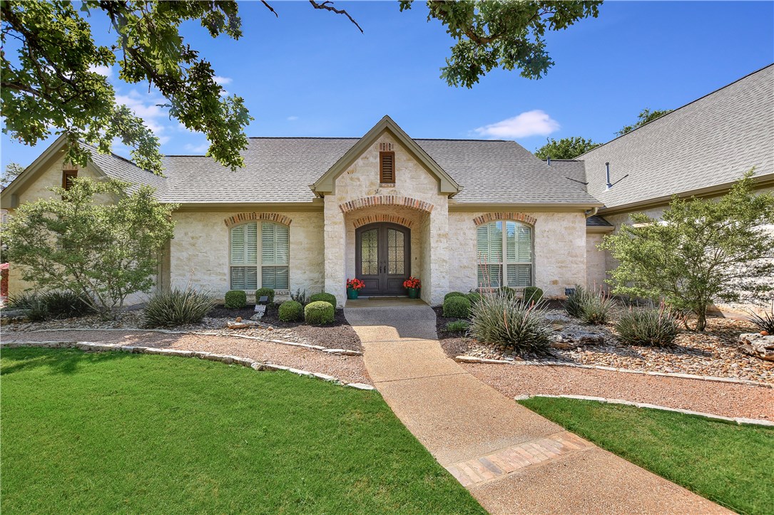 202 Orion Road Georgetown, TX 78633 - Photo 1 of 1 Pebble textured and brick accent walkway leads to covered front entry doors.