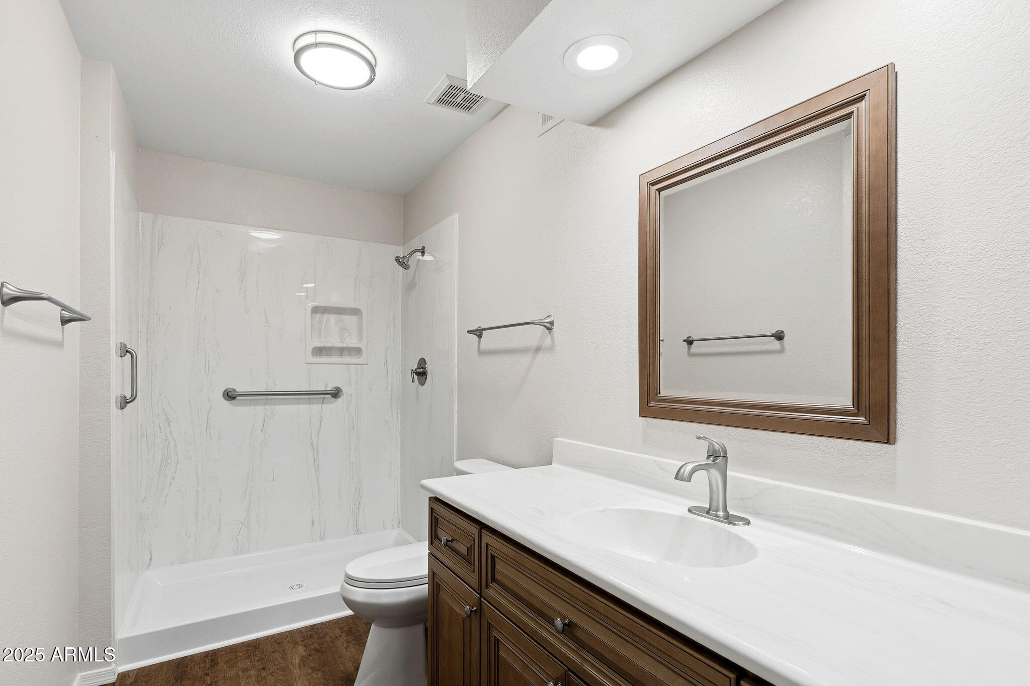 1021 South Greenfield Road, Unit 1148 Mesa, AZ 85206 - Photo 11 of 14 a bathroom with a sink a toilet a shower and a mirror