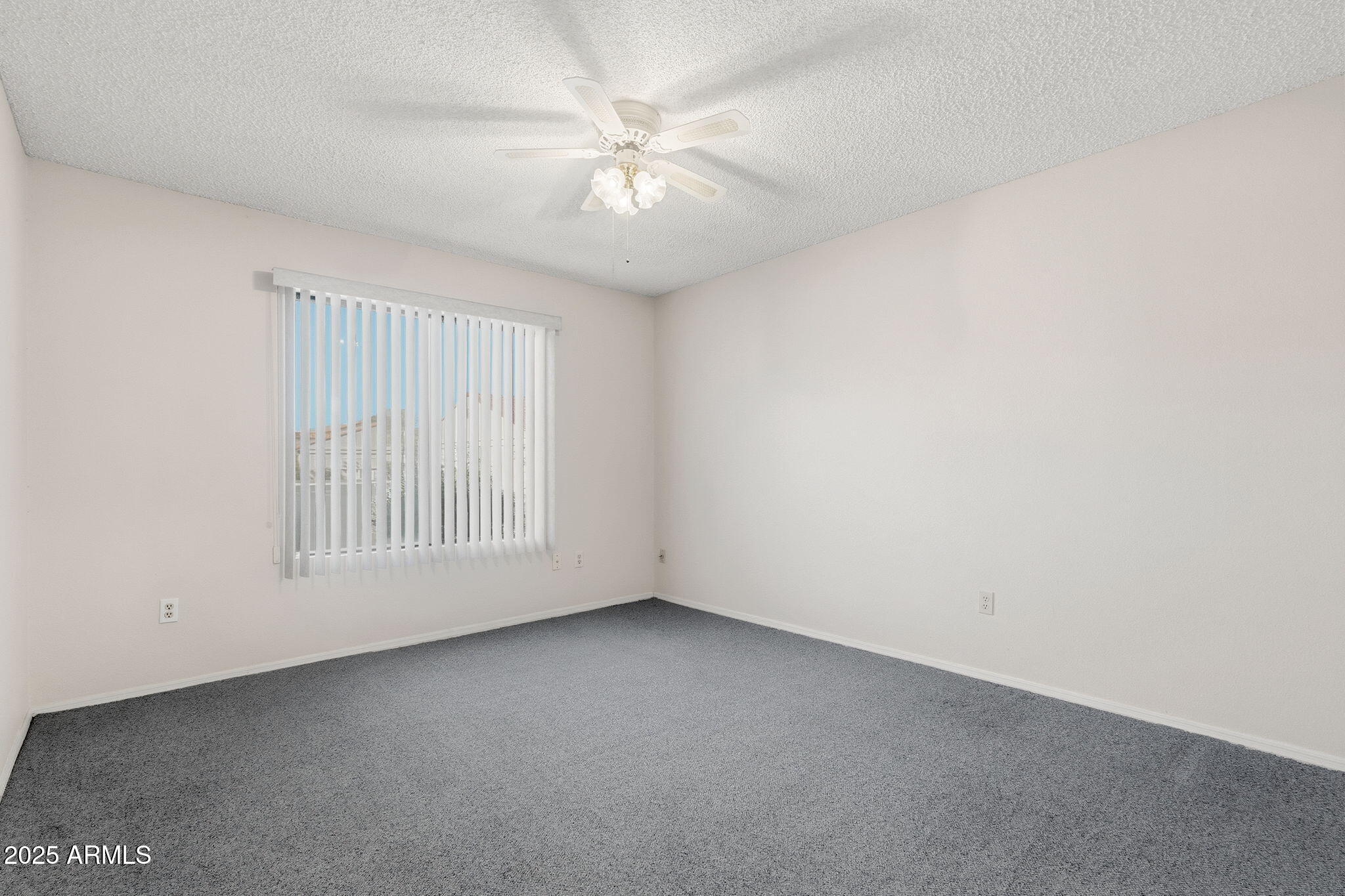 1021 South Greenfield Road, Unit 1148 Mesa, AZ 85206 - Photo 8 of 14 an empty room with windows and fan