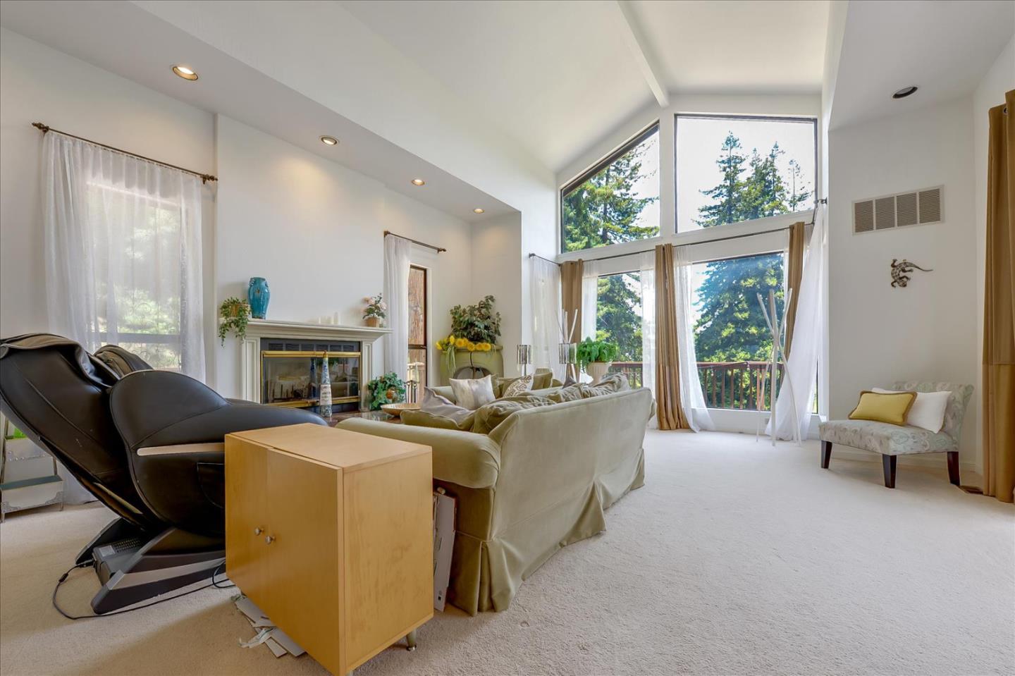35 Echo Lane Woodside, CA 94062 - Photo 23 of 54 a living room with furniture a fireplace and a floor to ceiling window