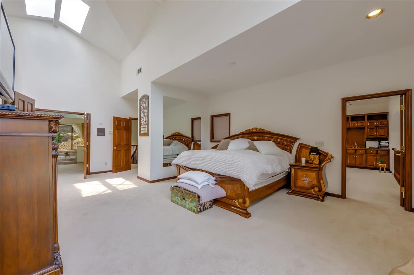 35 Echo Lane Woodside, CA 94062 - Photo 28 of 54 a spacious bedroom with a bed and a walk in closet