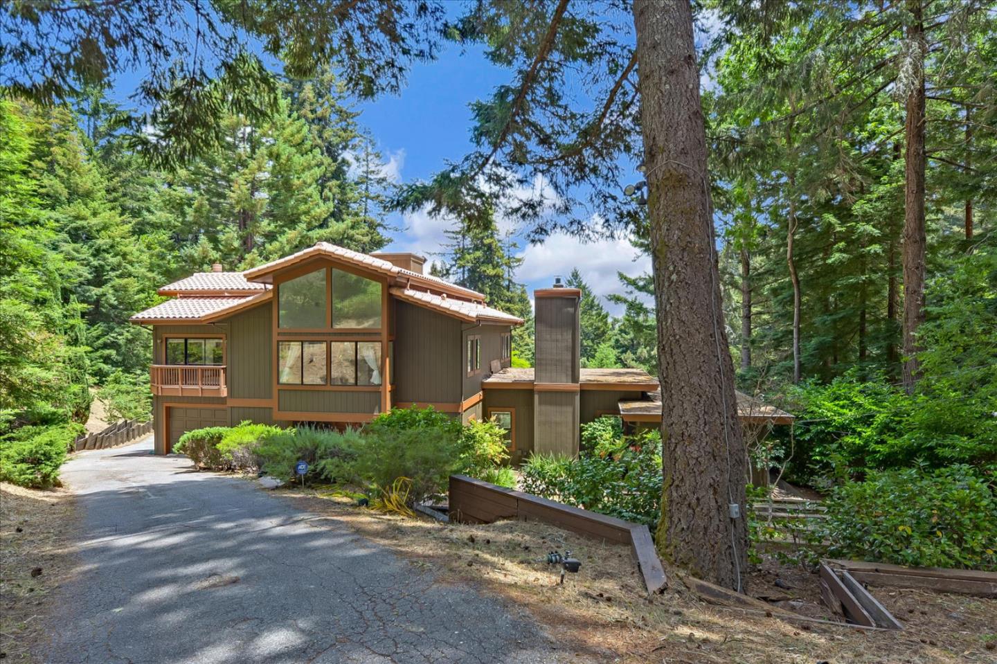 35 Echo Lane Woodside, CA 94062 - Photo 3 of 54 a view of a brick house with a small yard plants and large tree
