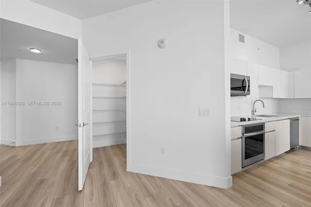 a bathroom with a granite countertop sink a toilet and shower