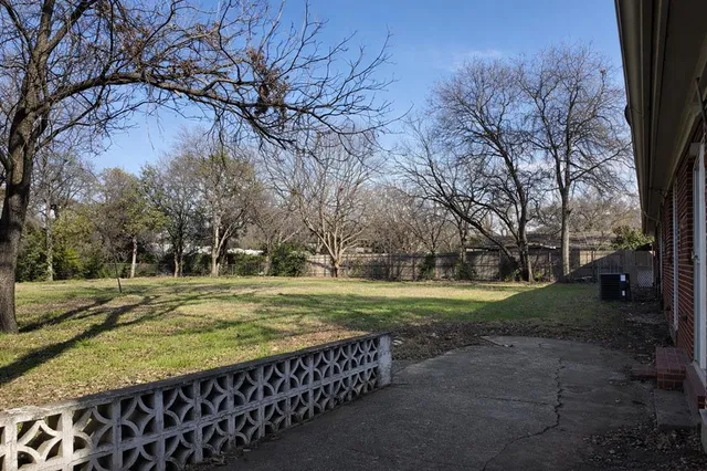 a view of a backyard with large trees