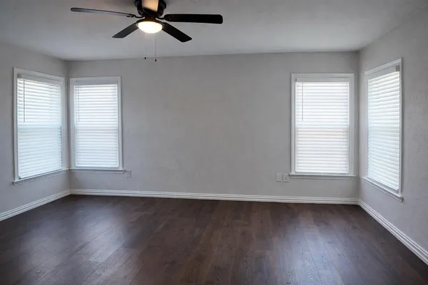 a view of wooden floor and windows in a room