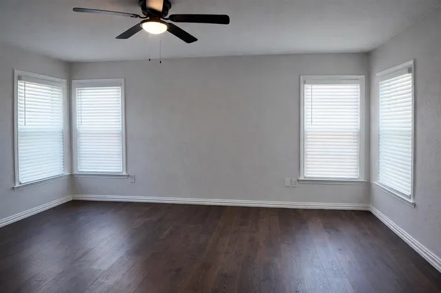 a view of wooden floor and windows in a room