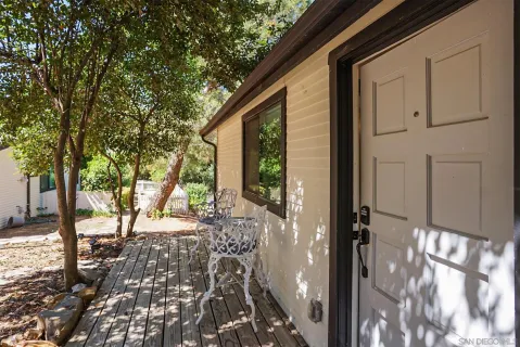 a view of a house with backyard and sitting area