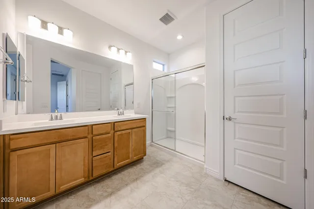 a spacious bathroom with a shower and a sink