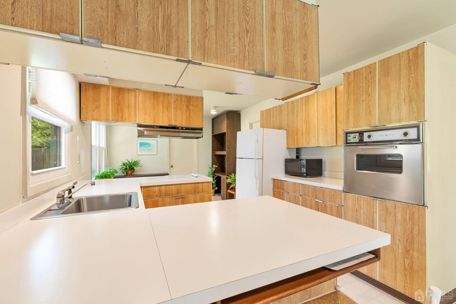 117 Drake Road Somerset, NJ 08873 - Photo 15 of 42 a large white kitchen with a large window and stainless steel appliances