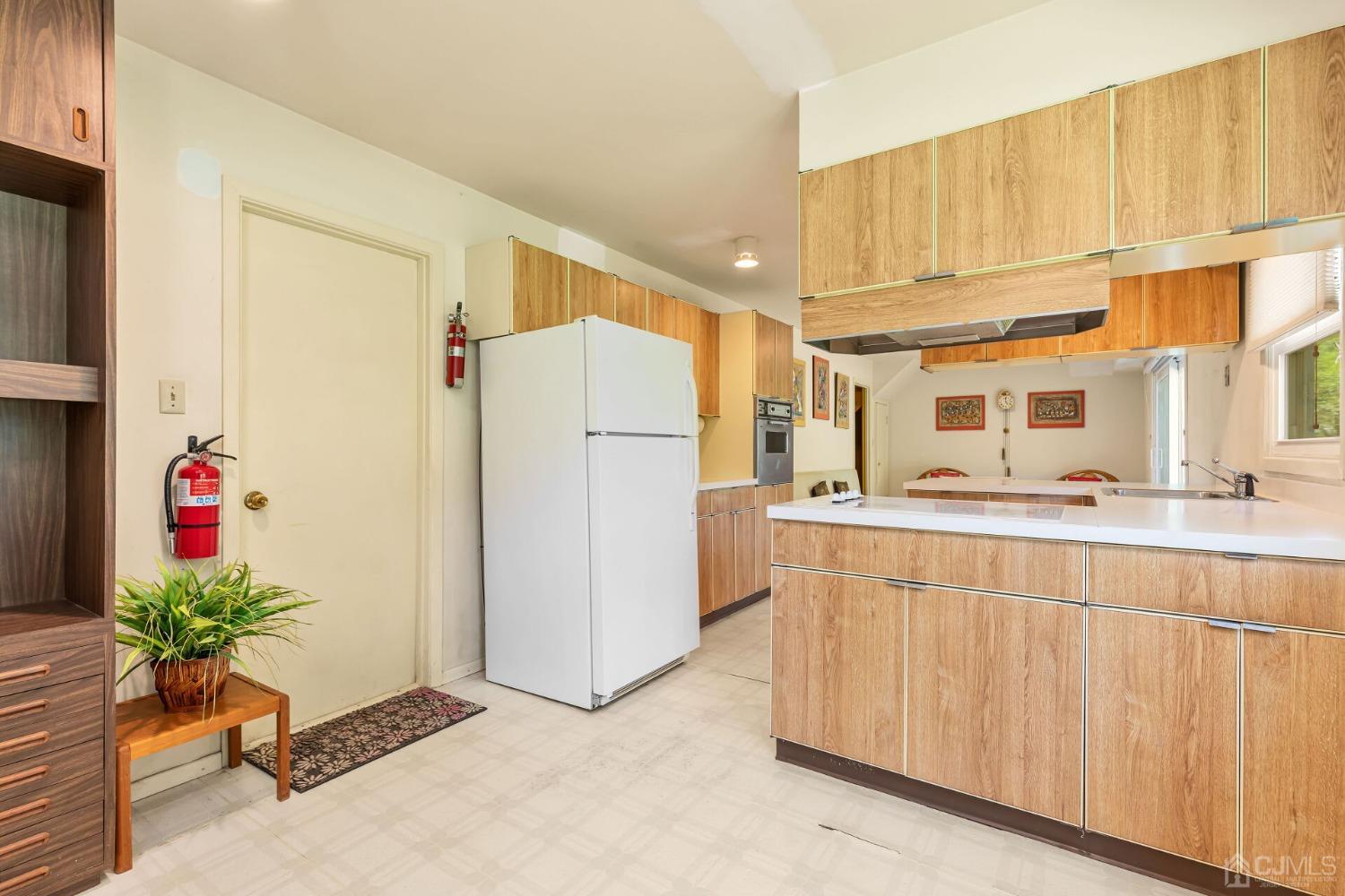 117 Drake Road Somerset, NJ 08873 - Photo 19 of 42 a kitchen with refrigerator and cabinets