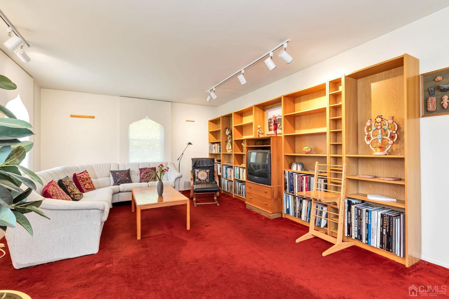 117 Drake Road Somerset, NJ 08873 - Photo 4 of 42 a living room with furniture and a book shelf
