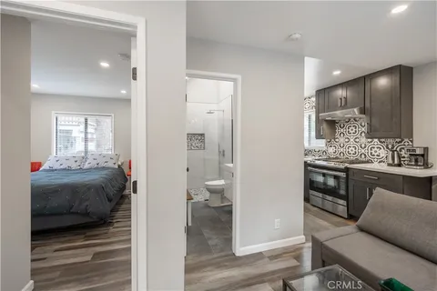 a en suite bathroom with a granite countertop sink and a mirror