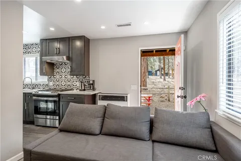 a living room with furniture and kitchen view