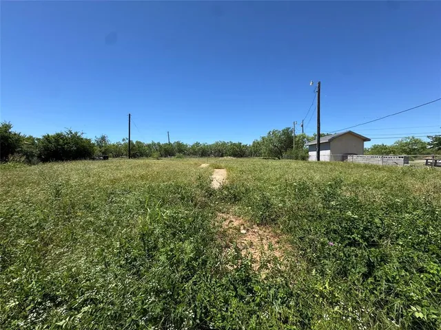 a view of a field with an ocean view