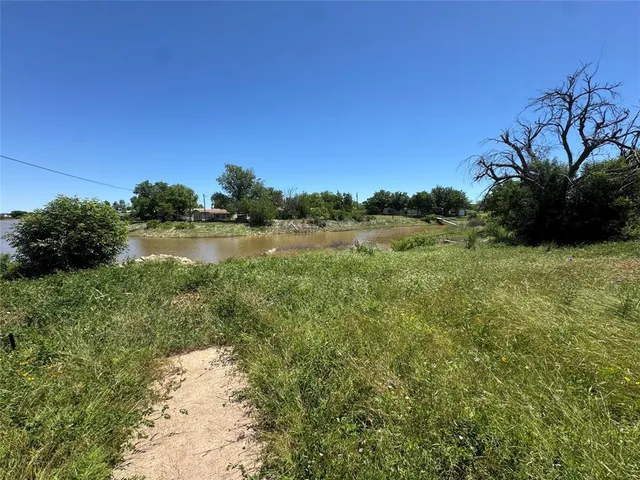 a view of a lake with a yard