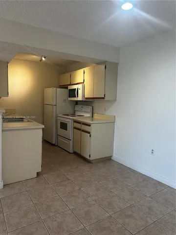 a kitchen with stainless steel appliances a sink and a refrigerator