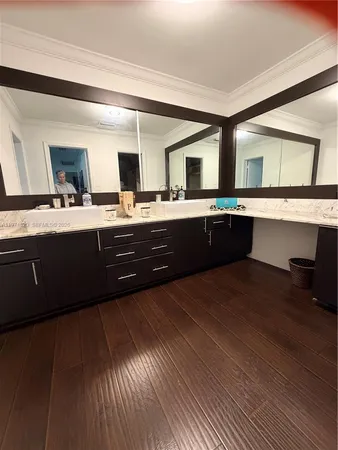 a large kitchen with granite countertop a sink and dishwasher a stove with wooden floor