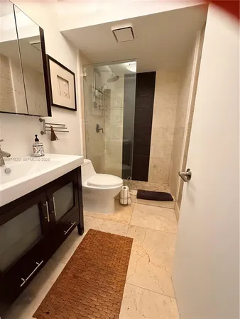 a bathroom with a sink a toilet and mirror