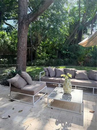 a view of patio with couches and a fire pit
