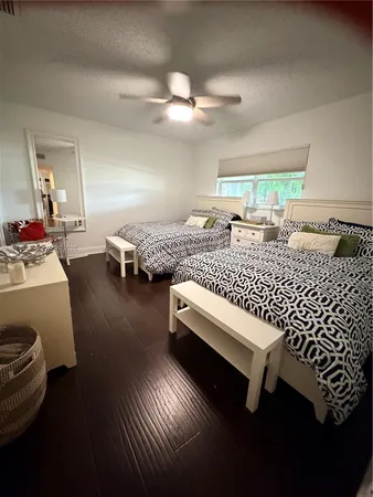 a bedroom with furniture and wooden floor
