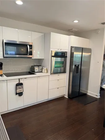 a kitchen with stainless steel appliances a refrigerator a stove a microwave and cabinets
