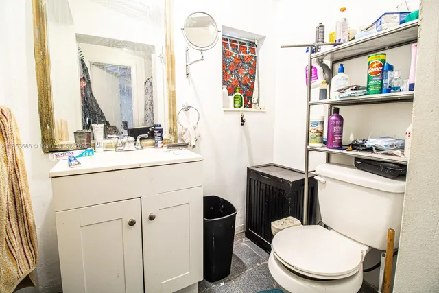 a bathroom with a sink a toilet and a mirror