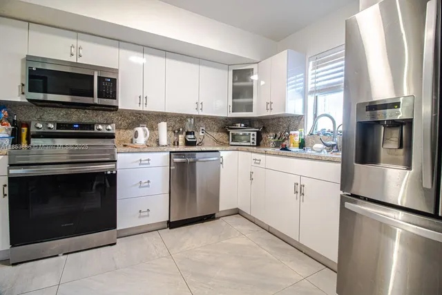 a kitchen with a sink stove and microwave