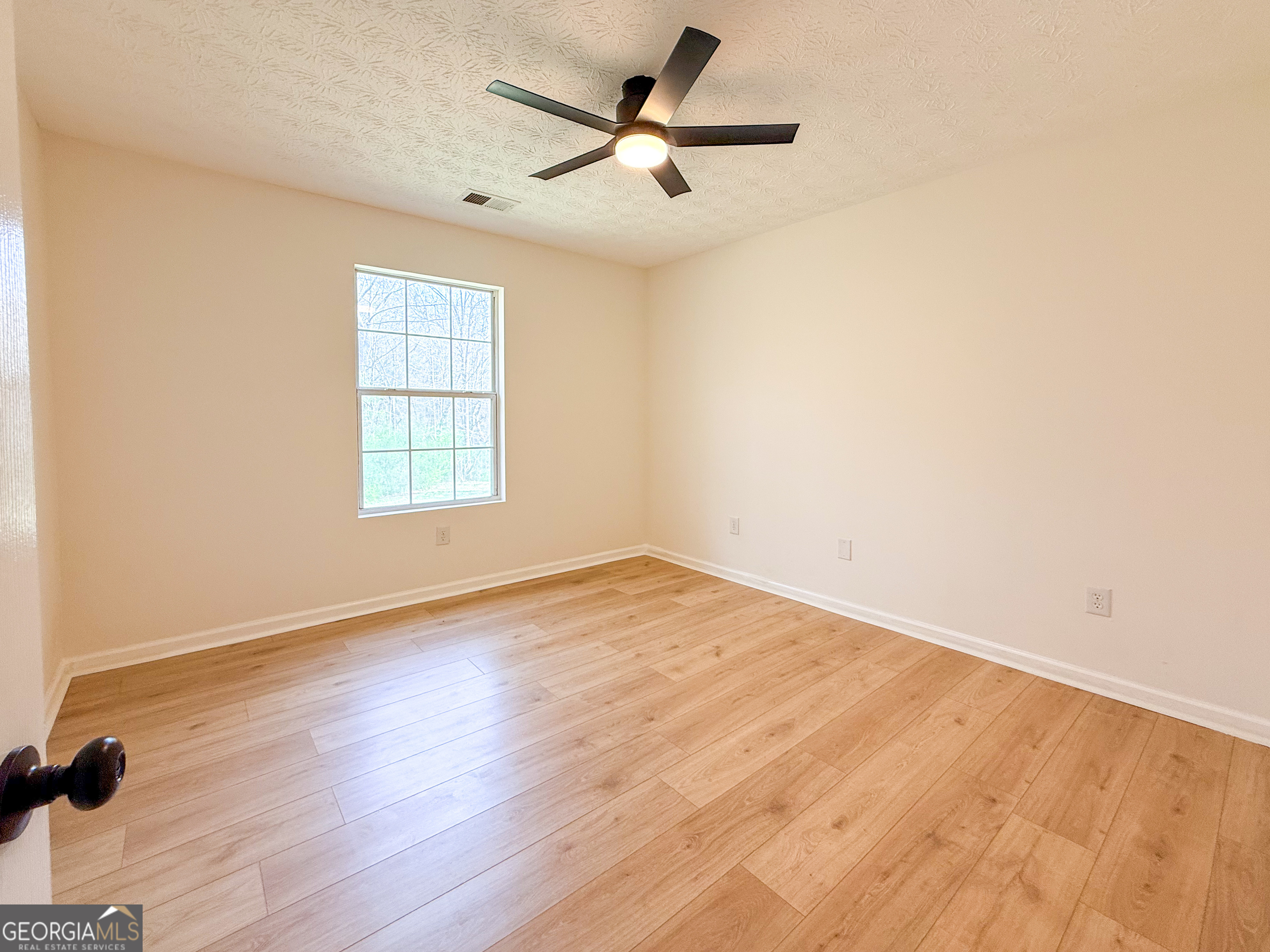 1492 Highway 198 Carnesville, GA 30521 - Photo 14 of 25 wooden floor in an empty room with a window