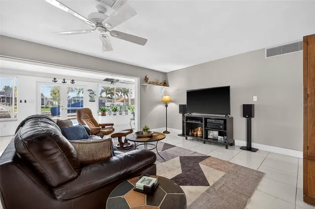 a living room with furniture and a flat screen tv with wooden floor