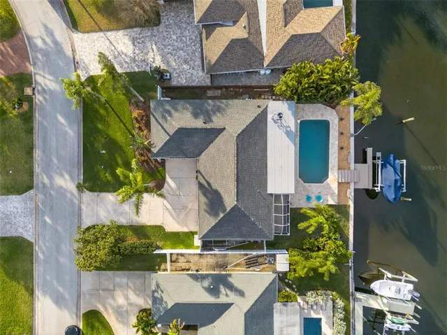 an aerial view of a house with a yard and fountain