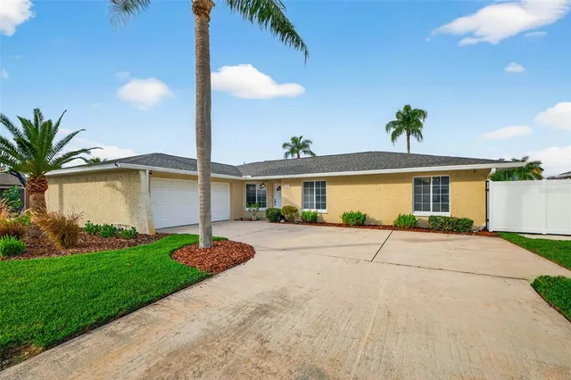 a front view of a house with a garden and patio