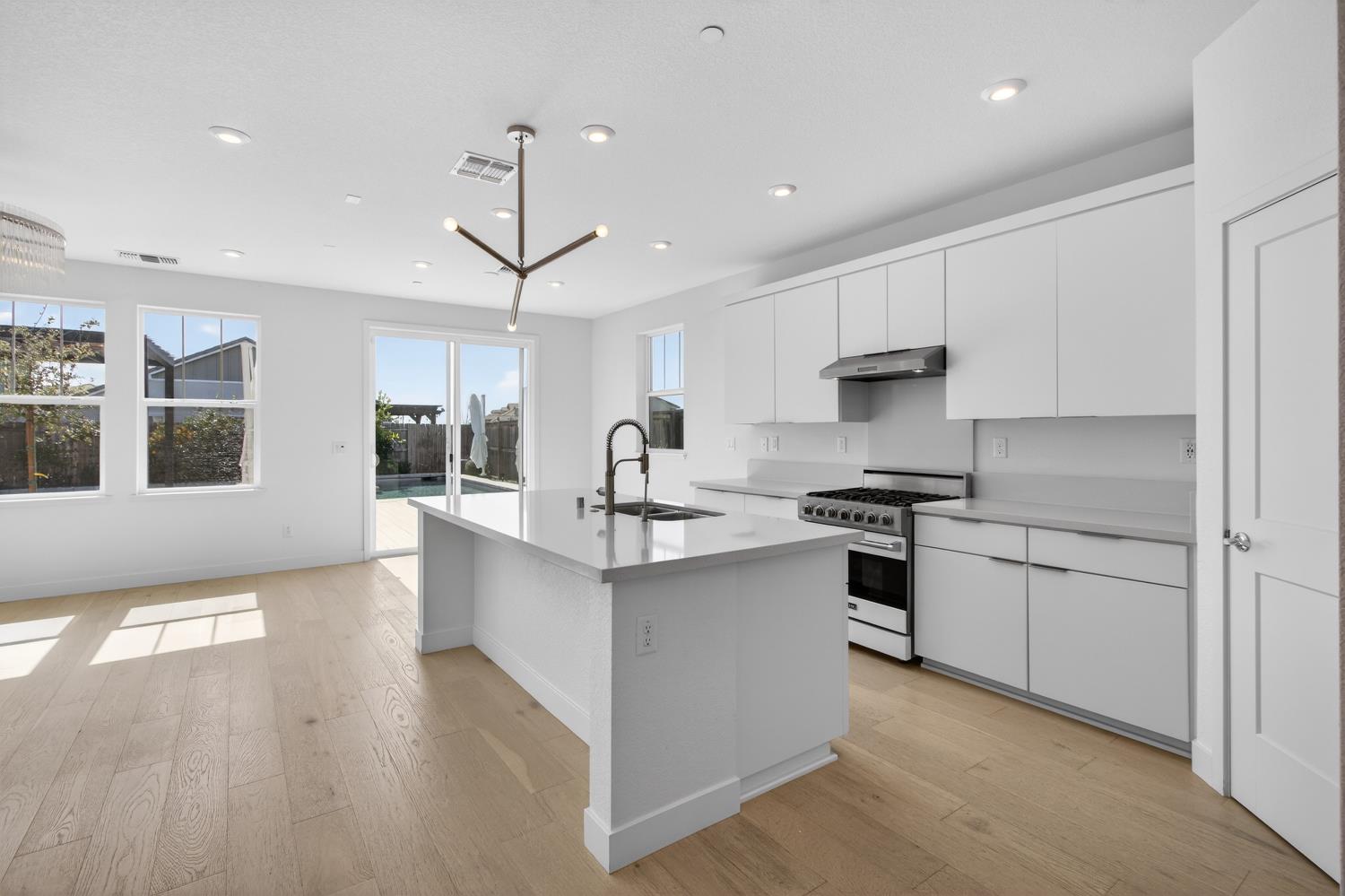 2883 Ridgecrest Drive Lincoln, CA 95648 - Photo 8 of 42 a kitchen with stainless steel appliances a sink a stove a refrigerator cabinets and living room view