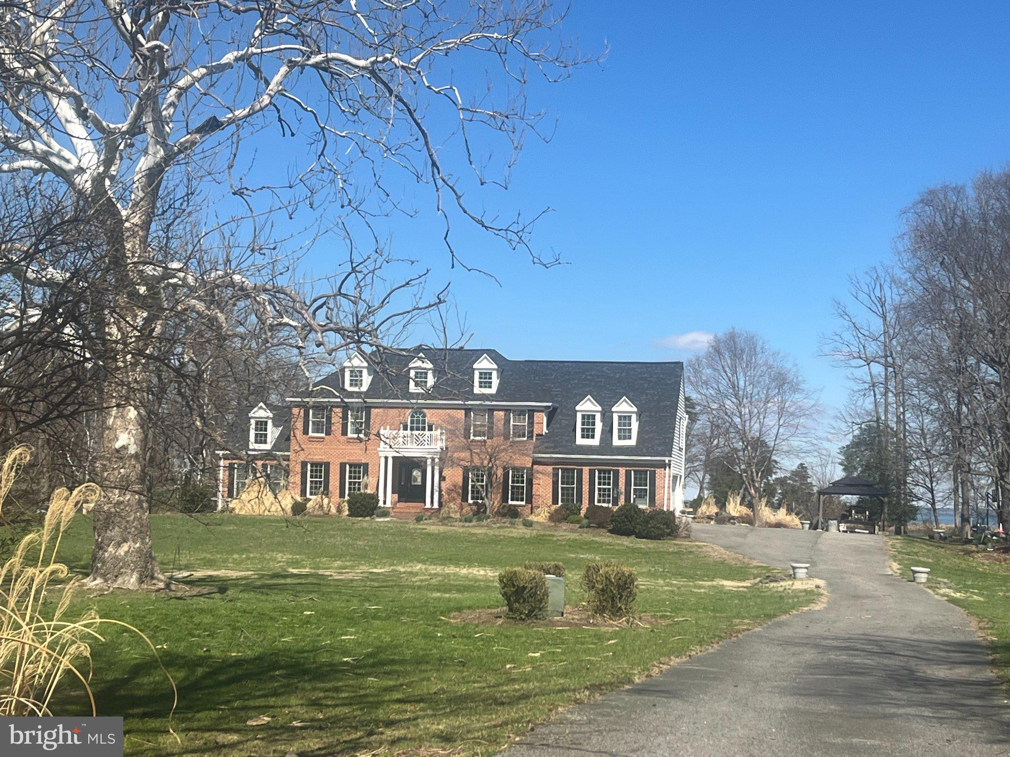 Elegant brick home on sprawling grounds.