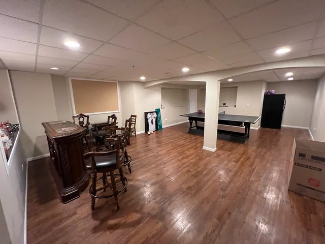 a view of a dining room with furniture and wooden floor