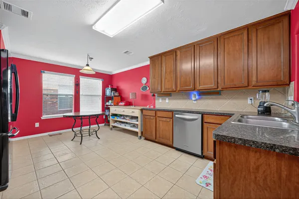 a kitchen with stainless steel appliances granite countertop a stove sink and cabinets