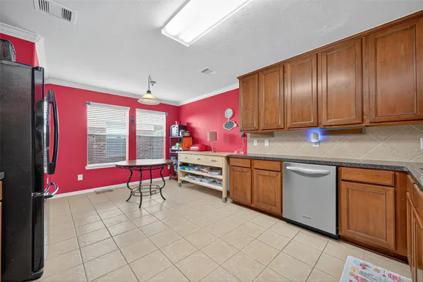 a kitchen with stainless steel appliances granite countertop a stove sink and cabinets