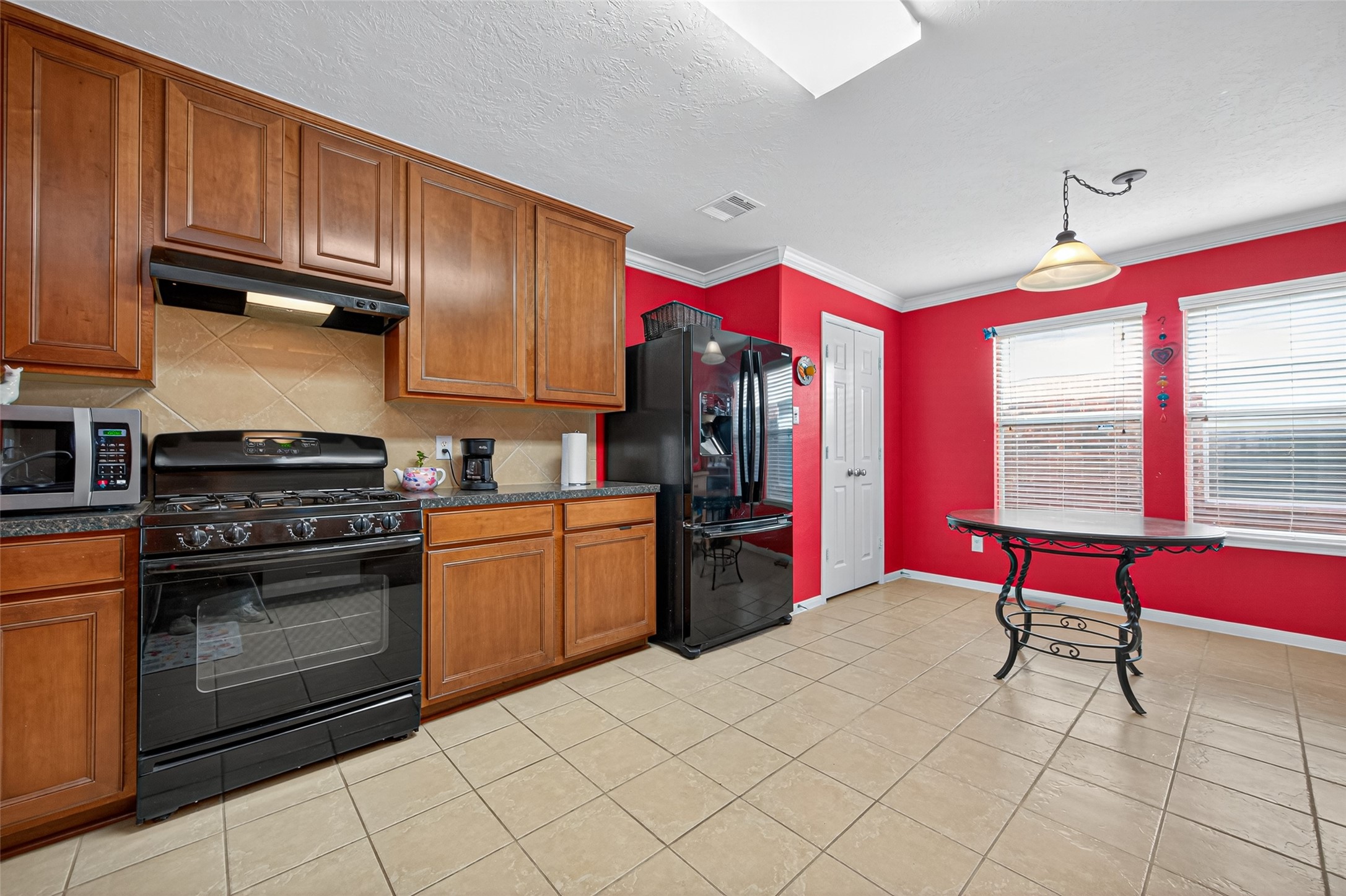 22402 Bridgestone Ridge Drive Spring, TX 77389 - Photo 16 of 49 a kitchen with stainless steel appliances granite countertop a stove cabinets and wooden floor