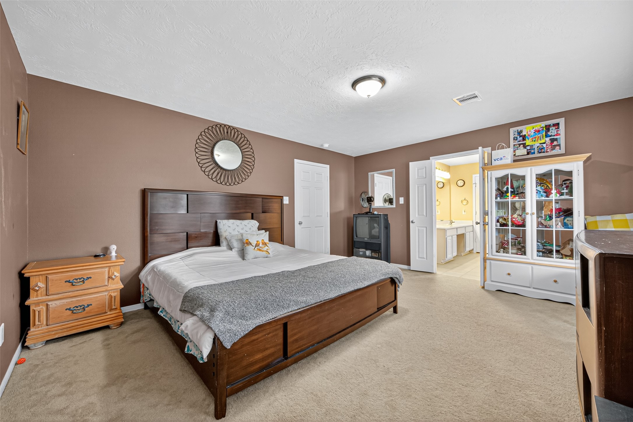 22402 Bridgestone Ridge Drive Spring, TX 77389 - Photo 25 of 49 a bedroom with a bed and a cabinets