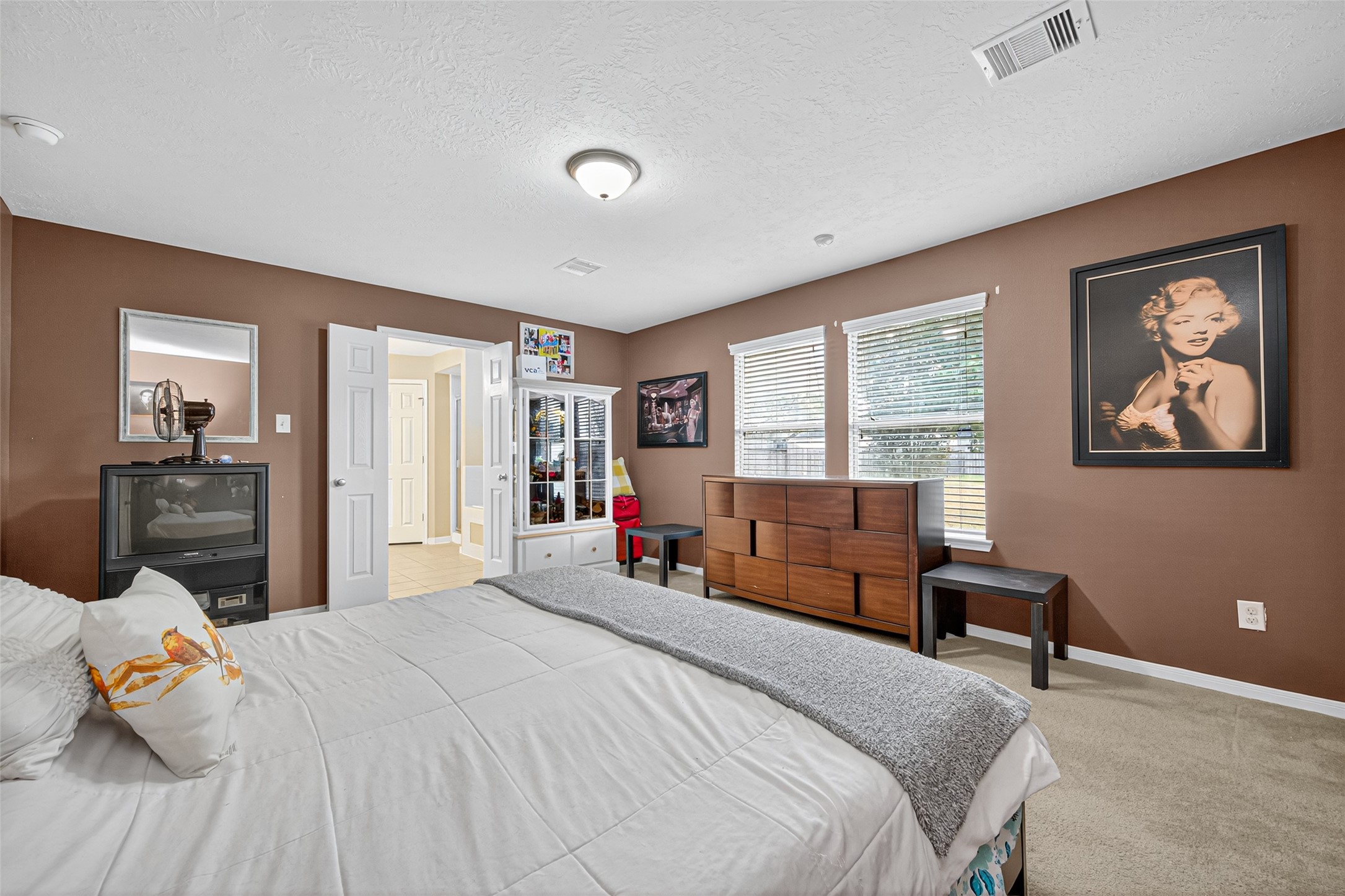 22402 Bridgestone Ridge Drive Spring, TX 77389 - Photo 26 of 49 a bedroom with a bed and wooden floor